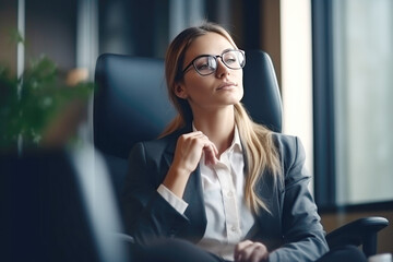 Young woman relaxing in office chair at workplace