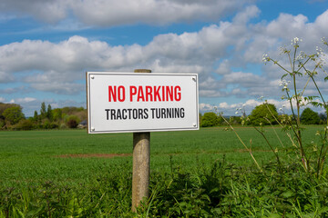 No Parking, tractors turning sign at the entrance to a field