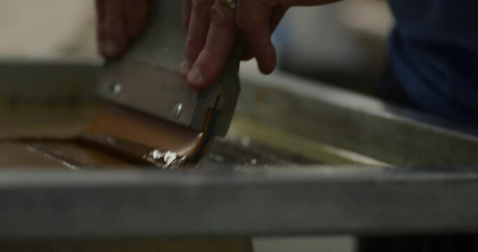 Ink Being Applied During Screen Printing Process
