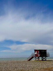 Lifeguard tower on the sea with a pebble beach
