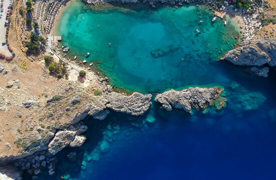 Aerial birds eye view drone photo Saint Paul bay near village Lindos, Rhodes island, Dodecanese, Greece. Sunny panorama with lagoon and clear blue water. Famous tourist destination in South Europe © oleg_p_100