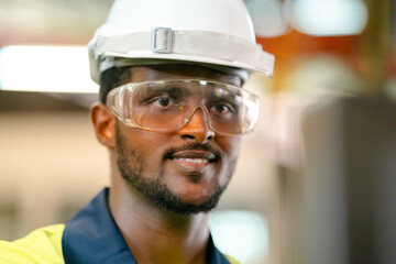 Production engineers in safety wear are assisting adjusting and maintaining CNC or factory machine, Male workers technician examining control the industrial tool, professional men at work in industry