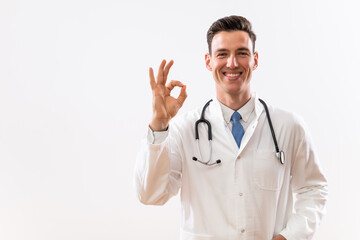 Fototapeta premium Portrait of young doctor showing ok sign.