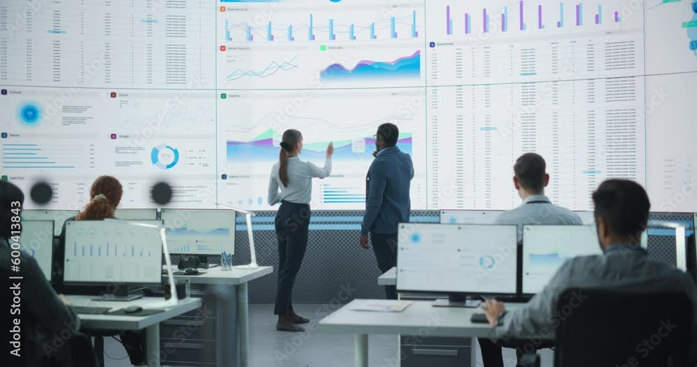 Poster Black Male Financial Data Analysts And Caucasian Female Project Manager Having A Meeting In Monitoring Office With Analytics Feed On Big Digital Screen. Consulting Firm With Employees Behind Computers