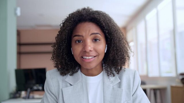 Web cam view of smiling African American businesswoman, business woman waving hand making video call in office for remote work at job, online conference lesson training, telework, e-learning concept.