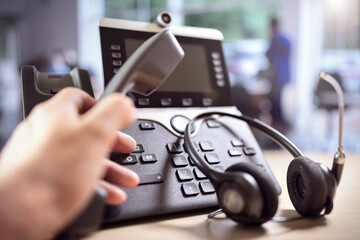Headset headphones and dialing a telephone in call center office concept for communication, contact...