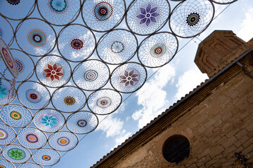Crochet awning with drawings of mandalas in circles forming a triangle, manual work with aerial...