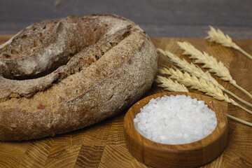 Bread on a wooden board and wheat. flour concept
