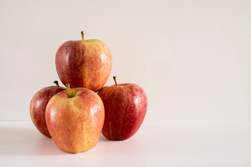 Three fresh red apples on a white background.