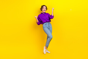 Full lenght photo of lovely young lady raise fists lottery wear trendy violet smart casual garment isolated on yellow color background
