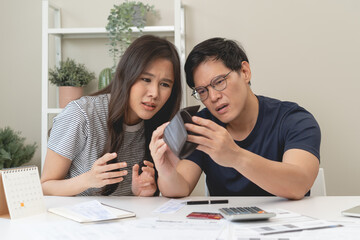 household finance debt concept, wife and husband calculate monthly family expense and worrying about credit card debt.