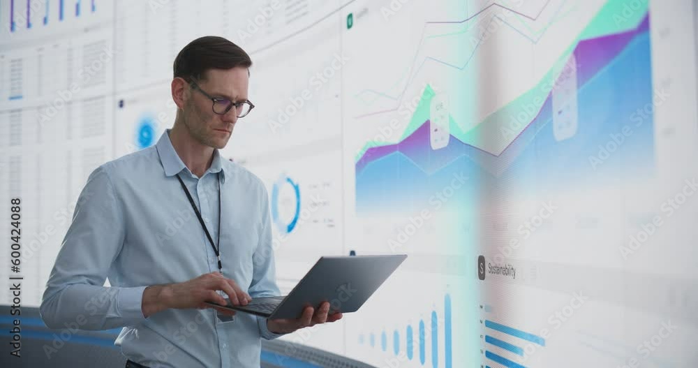 Aufkleber caucasian male business analyst with laptop computer standing next to big digital screen with graphs