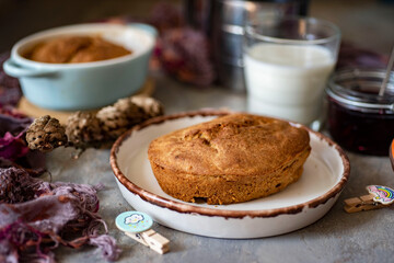 Breakfast for the whole family: carrot casserole in a beautiful clay plate on a gray background. Delicious dessert for dinner and lunch. Close-up.