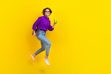 Full length photo of running it specialist girl junior programmer hold coffee hurry up her coworking isolated on yellow color background