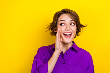 Photo of nice cheerful person hand near mouth communicate look empty space isolated on yellow color background - obrazy, fototapety, plakaty