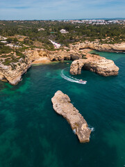 Aerial view of natural stone arch and blue ocean in Southern Portugal 