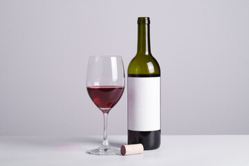 Close up red wine with the glass against gray background. Celebration party restaurant menu with copy space for text.