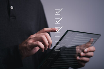 Businessman holding smartphone tick correct sign mark for document approve , project acceptance and quality assurance concept, Take an assessment, questionnaire, evaluation, online survey online exam.
