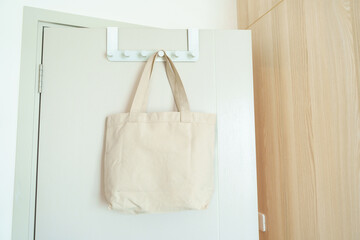 Eco friendly bag hanging on the door. Canvas Shopping tote bag. Zero waste, Reusable, Say No...