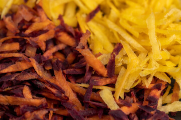 Finely grated red-orange carrots in the kitchen