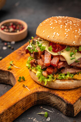 delicious homemade burgers of beef, cheese and vegetables on a wooden board, Hamburger. Fast food concept