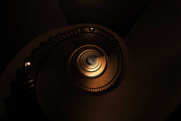 Spiral staircase in a tall multi-floor house, in the form of a 