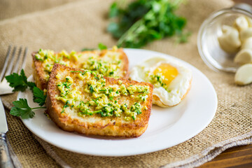 Fried croutons in batter with garlic and herbs in a plate.