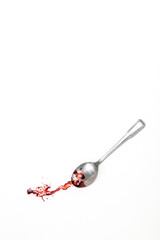 background with blood covered teaspoon