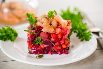 vinaigrette salad of boiled vegetables with salted fish in a plate