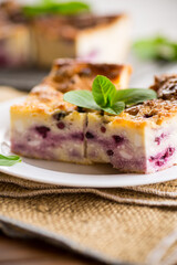 cooked cottage cheese casserole with berry filling in a plate