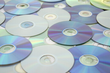 Lots of old CDs are laid out as a background.