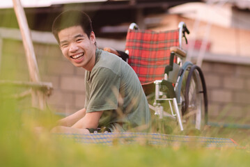 Asian young man with happiness exercise and playing in garden of park or home, hospital, school, nursery with green nature background at sunset, Positive photography and Good mental health concept.