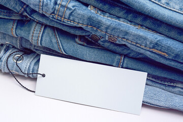 Lots of jeans pants in a stack. Denim background.