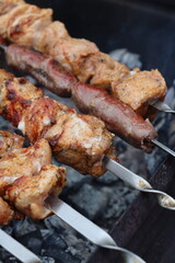 juicy pork meet is roasted on the fire in the grill