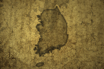 map of south korea on a old vintage crack paper background .