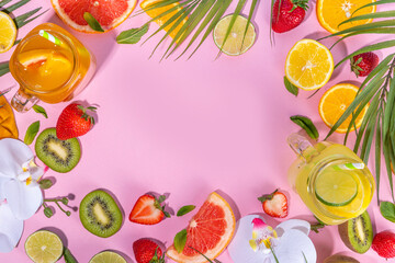 

Set of summer cold lemonade mocktails, with fresh fruits and citrus, tropical leaves and flowers, top view on pink background