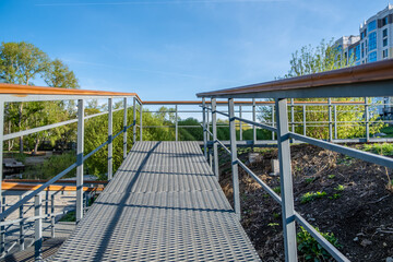 A walkway with a railing and a metal lattice floor.