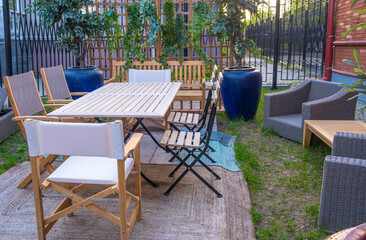 A place for office employees to relax on the street in the courtyard.A table with chairs for relaxing in the park.