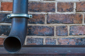 A drainpipe on a brick wall.