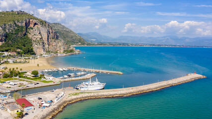 Aerial view of the port of Terracina, near Rome, in the Province of Latina, Italy. There are many boats moored at the marina. In the background are Sant'Angelo mount and the Lazio coast.