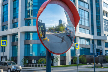 Reflection of the street in a spherical mirror in the city.