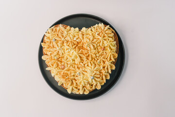 cake for the valentine's day. heart cake with vanilla cream on the black plate