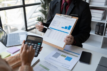 business team meeting Discuss strategy planning and calculating revenue performance with a new project plan. Financial and economic graphs with successful teamwork.