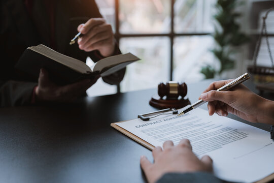Attorneys or lawyers who are reading the statute of limitations Consultation between male lawyers and business clients, tax and legal and legal services firms.
