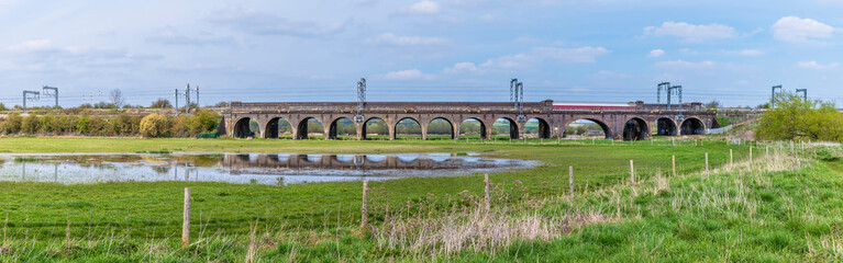 A view of the Irchester viaduct reflected in a pool near Wellingborough UK in the early summer