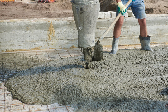 Construction worker concretes floors at a construction site