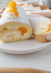 Swiss roll cake with mandarin orange filling on a platter