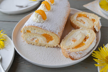 Swiss roll with mandarins and whipped cream filling