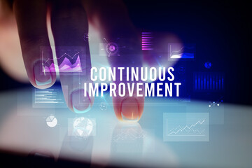 Finger touching tablet with business graphs and icons concept