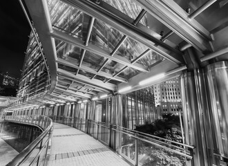Modern pedestrian walkway and traffic in downtown of Hong Kong city at night